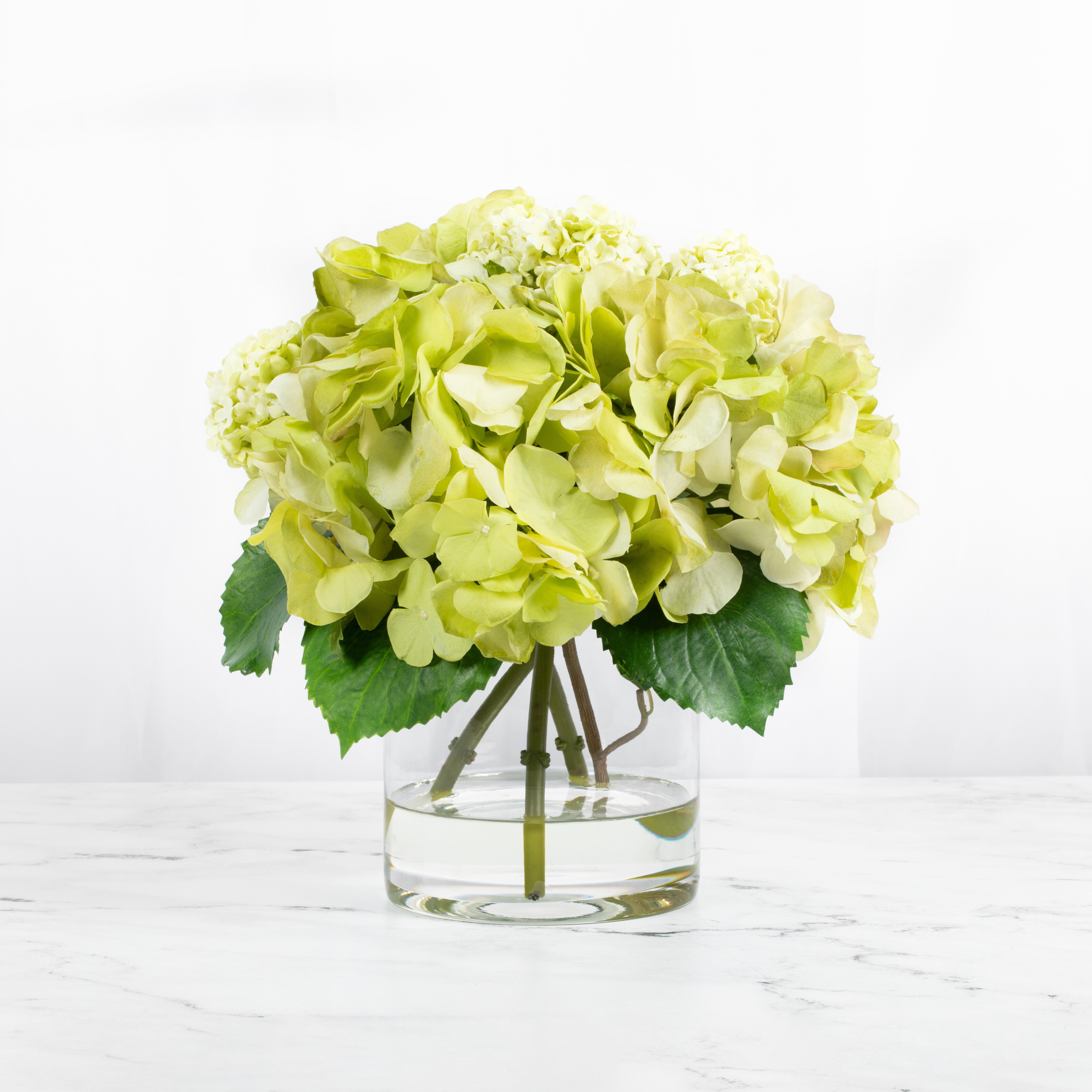 Silk hydrangea centerpiece arrangement in glass vase